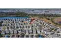 Wide aerial view of a residential community showcasing cozy houses near a serene lake and lush green spaces at 6834 Blue Moon Way, Sun City Center, FL 33573