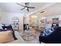 Open-concept living room showcasing stylish furniture, a ceiling fan, and a view into the kitchen at 3152 Karen Ave, Largo, FL 33774