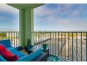 Enjoy city views from this relaxing balcony with outdoor seating and a vibrant blue and green color scheme at 400 64Th Ave # 508, St Pete Beach, FL 33706