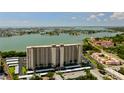 Stunning aerial view of high-rise condominium offering breathtaking views of the bay and surrounding waterfront community at 7050 Sunset S Dr # 208, South Pasadena, FL 33707