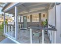 Inviting front porch featuring tile flooring, gray trim, seating, and charming decor at 11121 Roberts Ln, Riverview, FL 33578