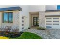 Beautiful home featuring stone accents, a two-car garage, and modern black-framed windows at 8421 Golden Beach Ct, Parrish, FL 34219