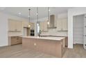 Open kitchen featuring a large center island, stainless hood, and pendant lighting at 8421 Golden Beach Ct, Parrish, FL 34219