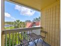 Relaxing balcony with a cozy table set and a peaceful view of the surrounding greenery at 2424 W Tampa Bay Blvd # B201, Tampa, FL 33607