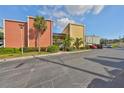 Exterior shot of colorful two-story condos with parking and manicured landscaping at 2424 W Tampa Bay Blvd # B201, Tampa, FL 33607
