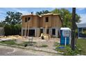 New two-story home under construction featuring block and wood framing and Mobley information sign at 1009 W Ohio Ave, Tampa, FL 33603