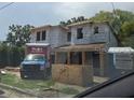 New home construction shows a modern, two-story home in progress with a blue truck in front at 1009 W Ohio Ave, Tampa, FL 33603