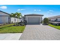 Beautiful single-Gathering home with well-kept lawn, palm tree, paved driveway, and two-car garage at 1975 Pepper Grass Dr, North Port, FL 34289