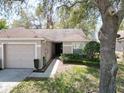 Charming single-story home with a well-manicured lawn and a one car garage at 35324 Whispering Pines Dr, Zephyrhills, FL 33541