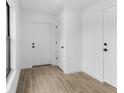Inviting foyer with wood-look tile flooring, white doors, and neutral decor at 4743 Michaler St, North Port, FL 34286
