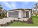 Charming single-story home with a gray brick driveway, gray garage door, and well-maintained landscaping at 4743 Michaler St, North Port, FL 34286