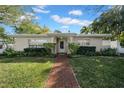 Beautifully landscaped front yard with lush green grass and a brick pathway leading to the front door at 216 21St Ne Ave, St Petersburg, FL 33704