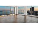 Elegant living room featuring hardwood floors, expansive windows, and stunning views of the water and city skyline at 2910 W Barcelona St # Ph-2303, Tampa, FL 33629