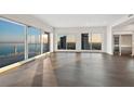 Bright living room with wood floors, floor to ceiling windows, and stainless steel appliances at 2910 W Barcelona St # Ph-2303, Tampa, FL 33629