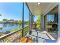 Enjoy the view from this cozy screened-in balcony with a grill and serene waterfront scenery at 6320 Grand Bahama Cir # 6320, Tampa, FL 33615