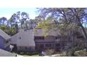 A great aerial view of this two-story condo surrounded by trees, lawn and nearby condominiums in a gated community at 103 Old Mill Pond Rd, Palm Harbor, FL 34683
