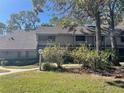 Charming townhome with a private balcony and mature landscaping nestled among trees in a tranquil setting at 103 Old Mill Pond Rd, Palm Harbor, FL 34683
