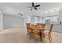Bright dining area with view into living area. Features tile floor and ceiling fan at 1264 Riserva Ln, Palm Harbor, FL 34683