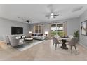 Comfortable living room with ample seating, large windows, and stylish decor, dining area to the right at 1264 Riserva Ln, Palm Harbor, FL 34683