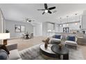 Open-concept living room featuring modern furnishings, neutral tones, and abundant natural light at 1264 Riserva Ln, Palm Harbor, FL 34683