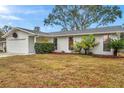 Charming single story home with a well-maintained lawn and colorful landscaping at 1753 Lucas Dr, Clearwater, FL 33759