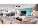 Open living room featuring a modern ceiling fan, neutral color palette and access to the kitchen at 1753 Lucas Dr, Clearwater, FL 33759