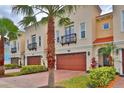 Attractive townhomes with private garages, balconies, and green spaces in a desirable community at 3222 W Empedrado St, Tampa, FL 33629