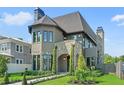Attractive two-story home boasting stone accents, arched entry, and manicured front yard at 807 W Park Ave, Tampa, FL 33602