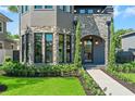 Elegant home featuring a stone archway, meticulous landscaping, and a welcoming front entrance at 807 W Park Ave, Tampa, FL 33602