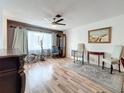 Bright living room featuring wood flooring, a ceiling fan, and furniture, creating a comfortable and inviting space at 8330 Vendome N Blvd, Pinellas Park, FL 33781