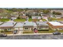 Charming single-story homes line a quiet street with manicured lawns and mature trees create inviting curb appeal at 8330 Vendome N Blvd, Pinellas Park, FL 33781
