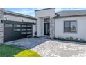 Single Gathering home exterior featuring a modern garage door and landscaping in a well maintained lawn at 8347 Golden Beach Ct, Parrish, FL 34219