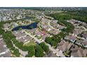 Aerial view of a community featuring water views, lush landscaping, and cozy homes with spacious driveways at 217 Oceania Ct, Apollo Beach, FL 33572
