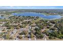 An aerial shot that captures a picturesque neighborhood near a big beautiful lake at 6009 County Line Rd, Spring Hill, FL 34606
