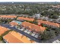Aerial view of townhouses showcases the community pool and well maintained landscaping with mature trees throughout the neighborhood at 6224 Vista Verde W Dr, St Petersburg, FL 33707