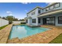 Inviting backyard pool and spa with brick pavers surround the home's outdoor living space at 10825 Charmwood Dr, Riverview, FL 33569