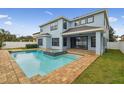 Inviting backyard pool and spa with brick pavers surround the home's outdoor living space at 10825 Charmwood Dr, Riverview, FL 33569