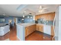 Bright kitchen with light wood cabinets, stainless steel appliances, and a breakfast bar overlooking the living area at 6051 Sun Blvd # 504, St Petersburg, FL 33715