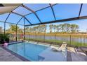 Sparkling pool with sun lounger and an expansive view of the trees at 14838 Paddock Pond Ave, Lithia, FL 33547