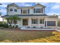 Charming two-story home featuring a welcoming front porch with classic columns and a well-manicured front yard at 3870 155Th E Ave, Parrish, FL 34219