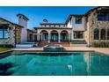 Beautiful pool area with spa, elegant stone accents, covered patio, and inviting outdoor space at 3901 Bayshore Ne Blvd, St Petersburg, FL 33703