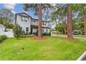 Charming two-story home with a luscious green lawn and mature shade trees at 4224 W Kensington Ave, Tampa, FL 33629