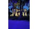 Nighttime view of the two-story home showcasing its well-lit facade and landscaped yard at 4224 W Kensington Ave, Tampa, FL 33629