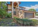 Inviting home featuring an arched entryway with stone steps and well-maintained landscaping for enhanced curb appeal at 513 Suwanee Cir, Tampa, FL 33606