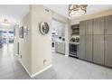 Hallway leading to kitchen with modern cabinetry, wine fridge, and bar shelving at 6093 Bahia Del Mar Cir # 375, St Petersburg, FL 33715