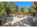 This backyard features a pool, outdoor fireplace, pergola and outdoor kitchen area, perfect for entertaining at 5701 S Macdill Ave, Tampa, FL 33611