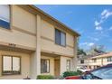 Well-kept townhome with a neutral exterior, complemented by lush green shrubs and a clear blue sky backdrop at 1470 Highland Ridge Cir, Brandon, FL 33510