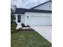 Charming home with a modern design and well-maintained landscaping around the front entrance and a two-car garage at 3739 Nandina Cir, Sun City Center, FL 33573
