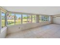 Sunroom featuring tile floors, multiple windows and water views at 8839 W Millpoint Rd, Riverview, FL 33578