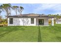 A large yard behind the house offers plenty of space for outdoor living at 3355 Moncrief Ave, North Port, FL 34286